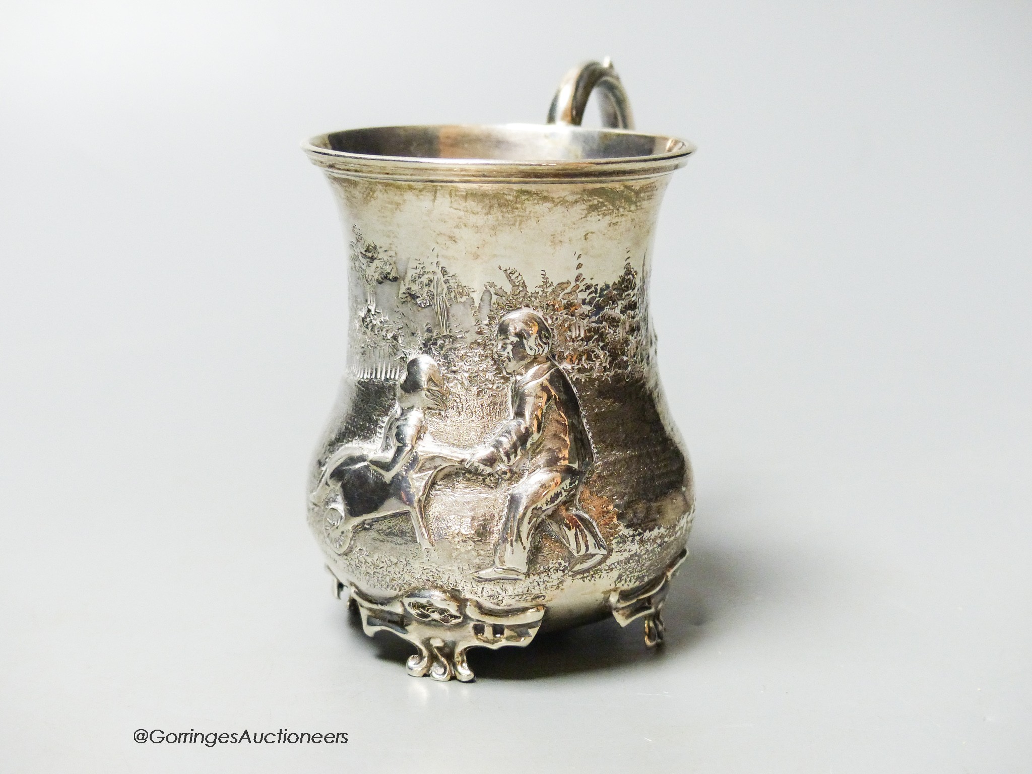 A Victorian silver christening mug, embossed with children and a wheelbarrow, George John Richards, London, 1855, 87mm, 83 grams.